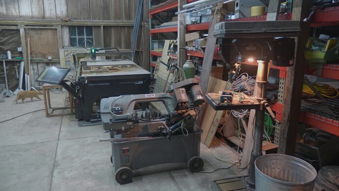 A view of our metal shop showing our drill press, metal band saw, and CNC plasma cutter.