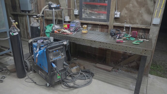 Our MIG welding setup with a nice welding table and a Miller 255 MIG welder.